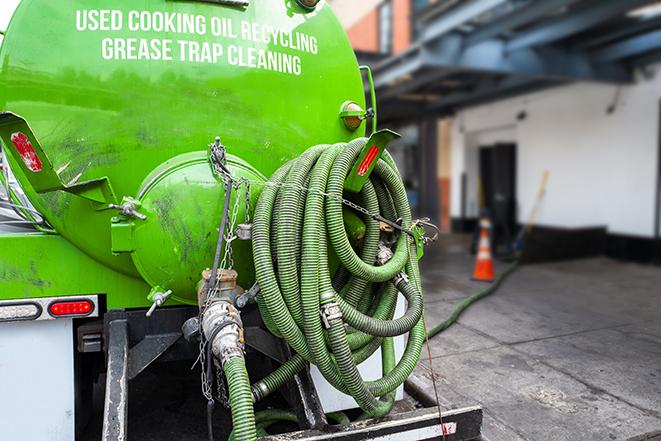 a grease trap pumping truck at a restaurant in Brooklyn, MS